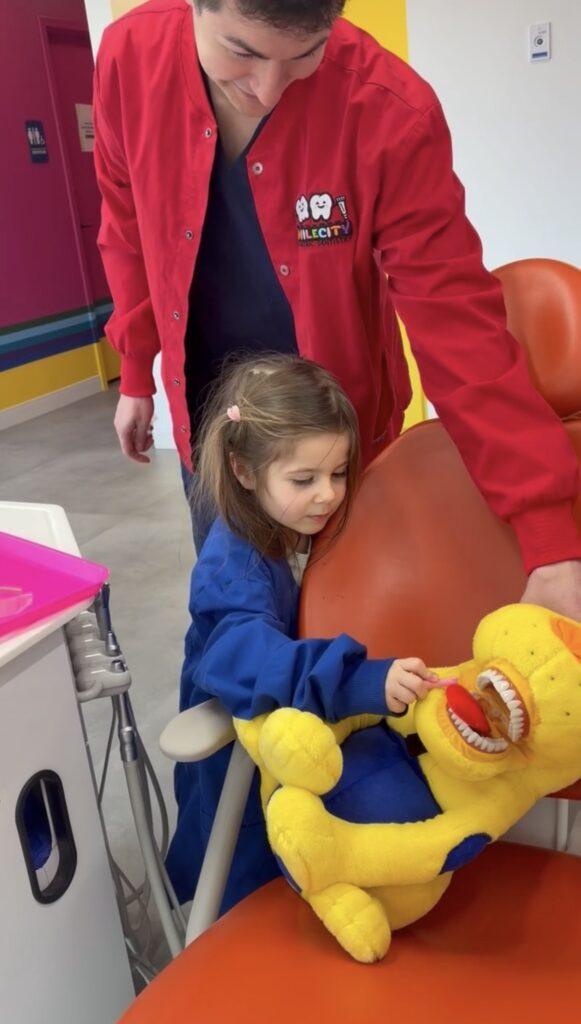 Happy Patient Learning to Brush at SmileCity Pediatric Dentistry in Leesburg VA